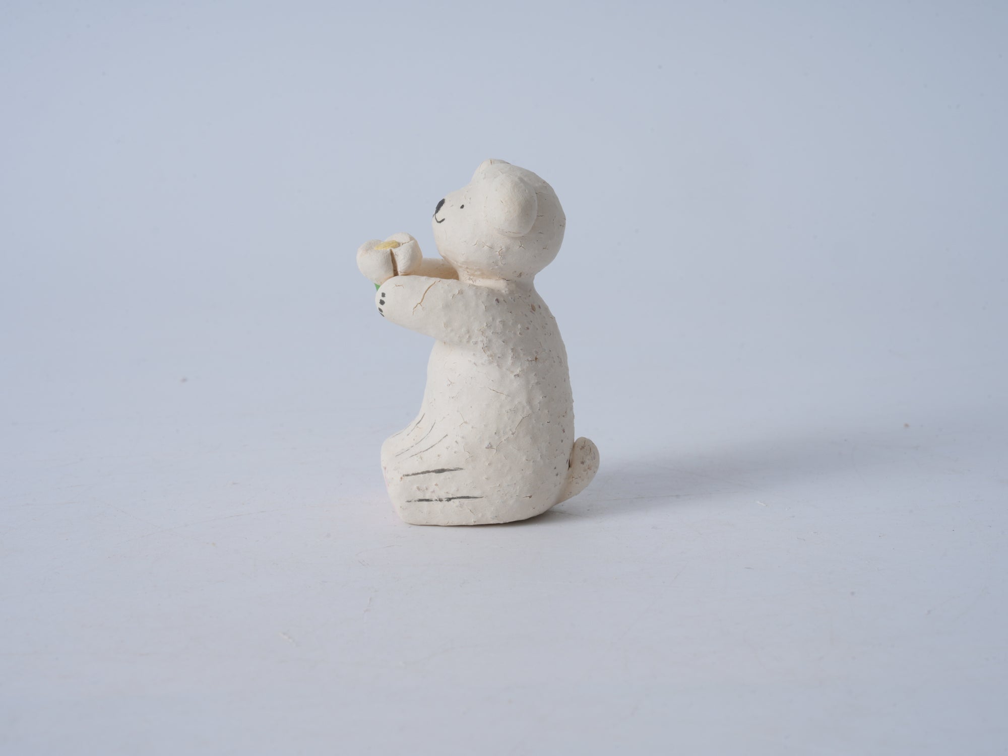 Small Animal Holding Flower Figurine