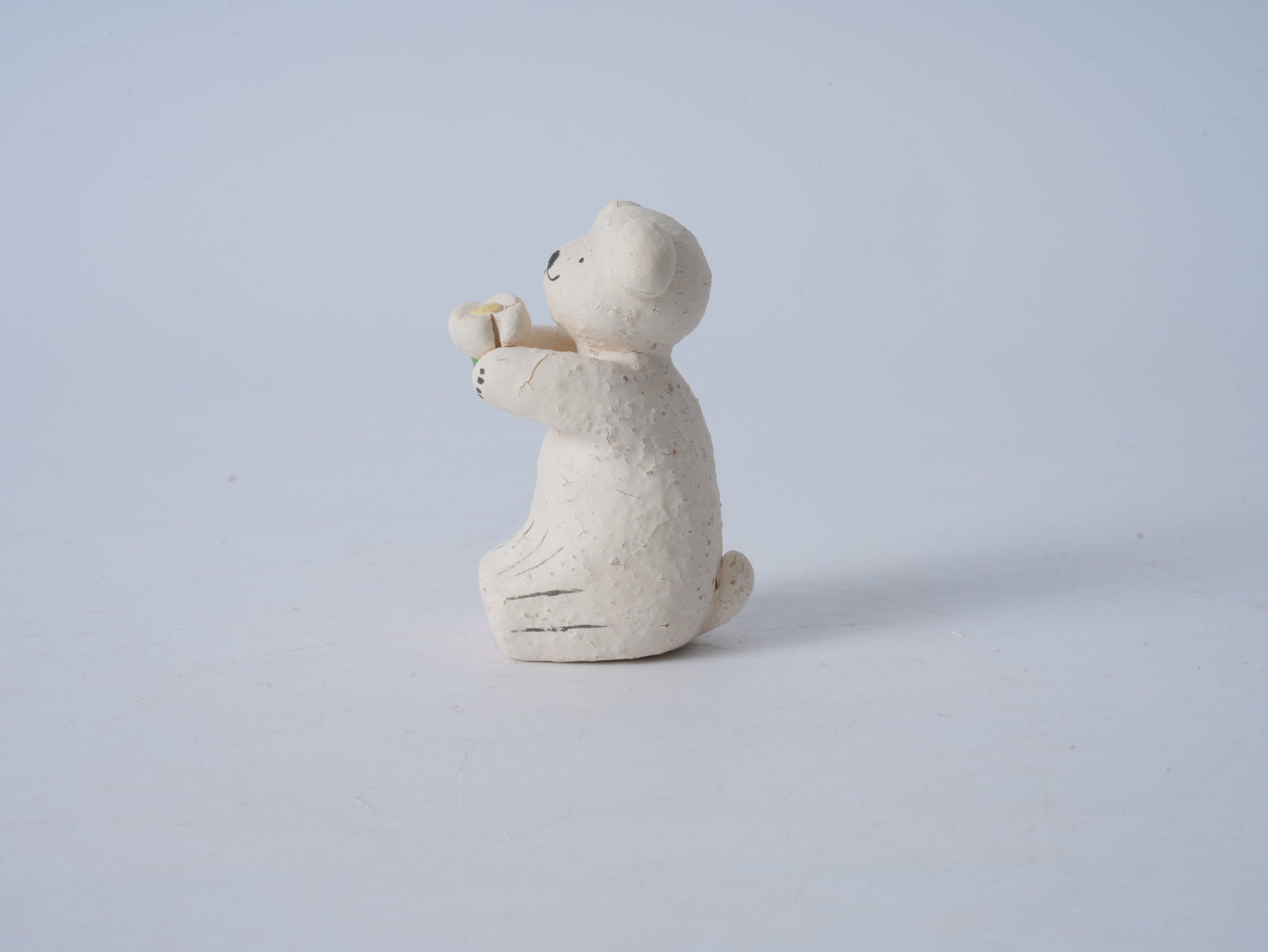 Small Animal Holding Flower Figurine
