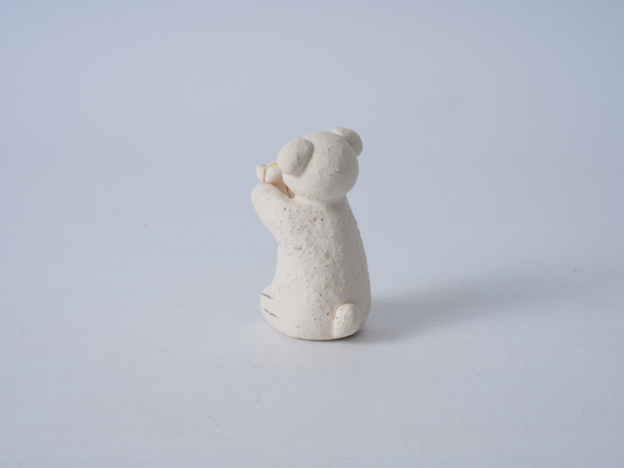 Small Animal Holding Flower Figurine