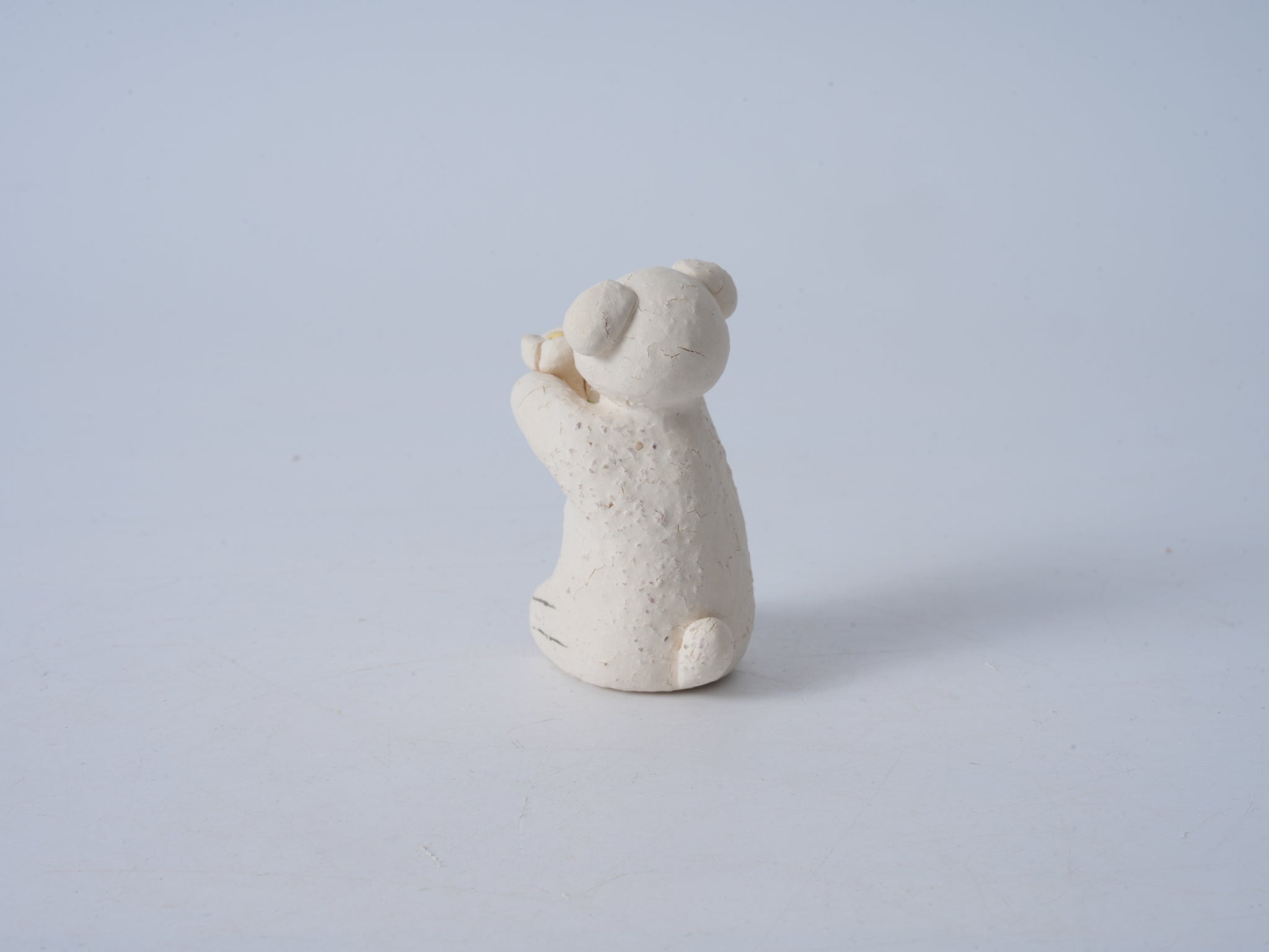 Small Animal Holding Flower Figurine