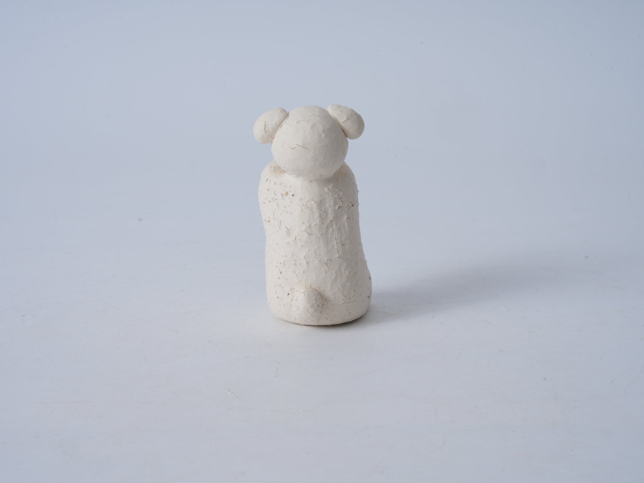 Small Animal Holding Flower Figurine