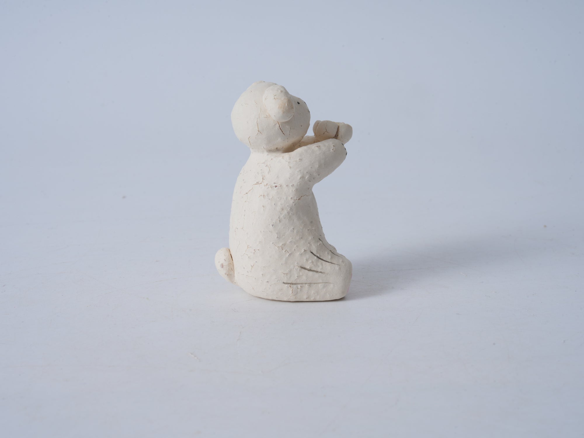 Small Animal Holding Flower Figurine