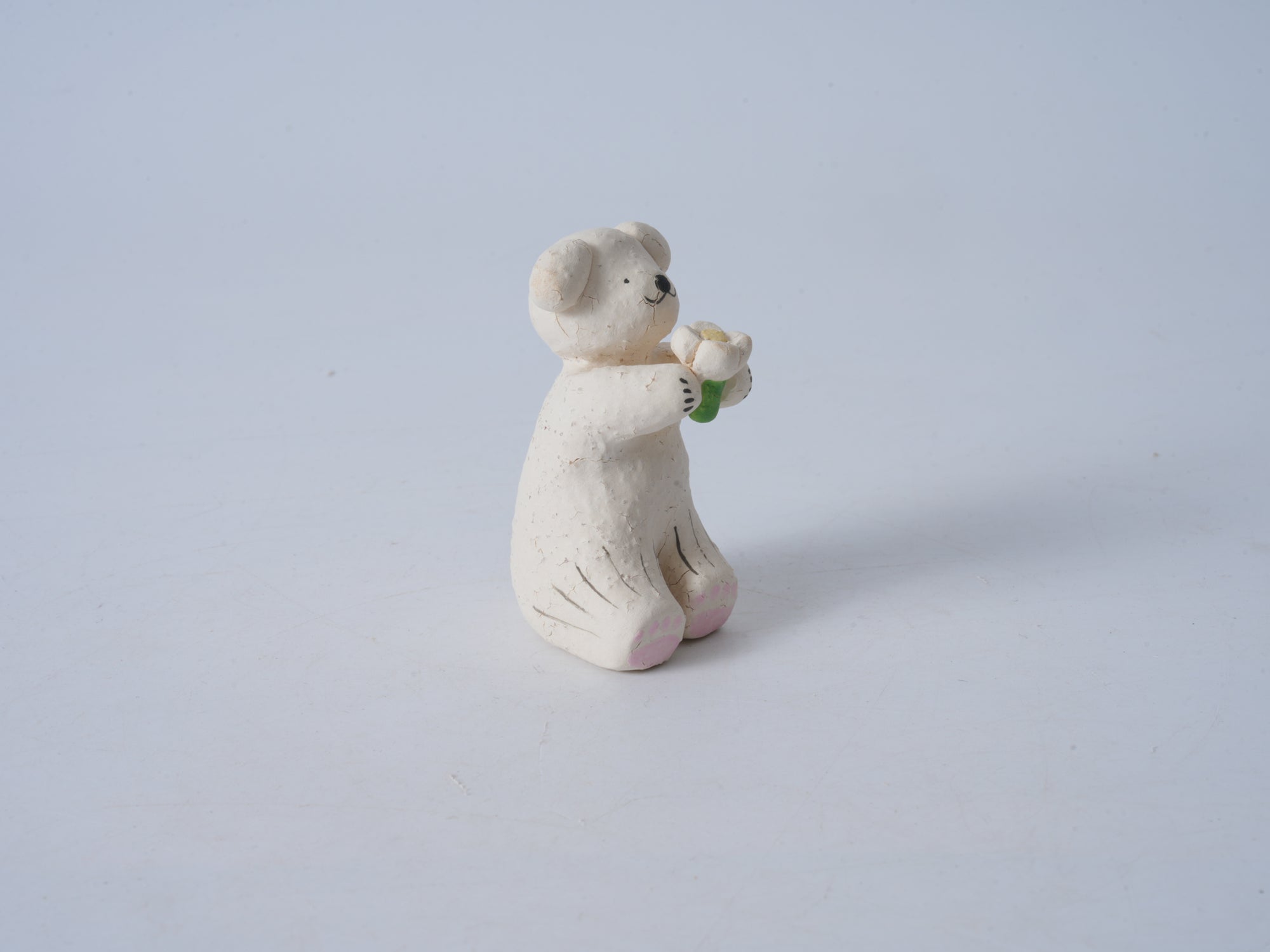 Small Animal Holding Flower Figurine