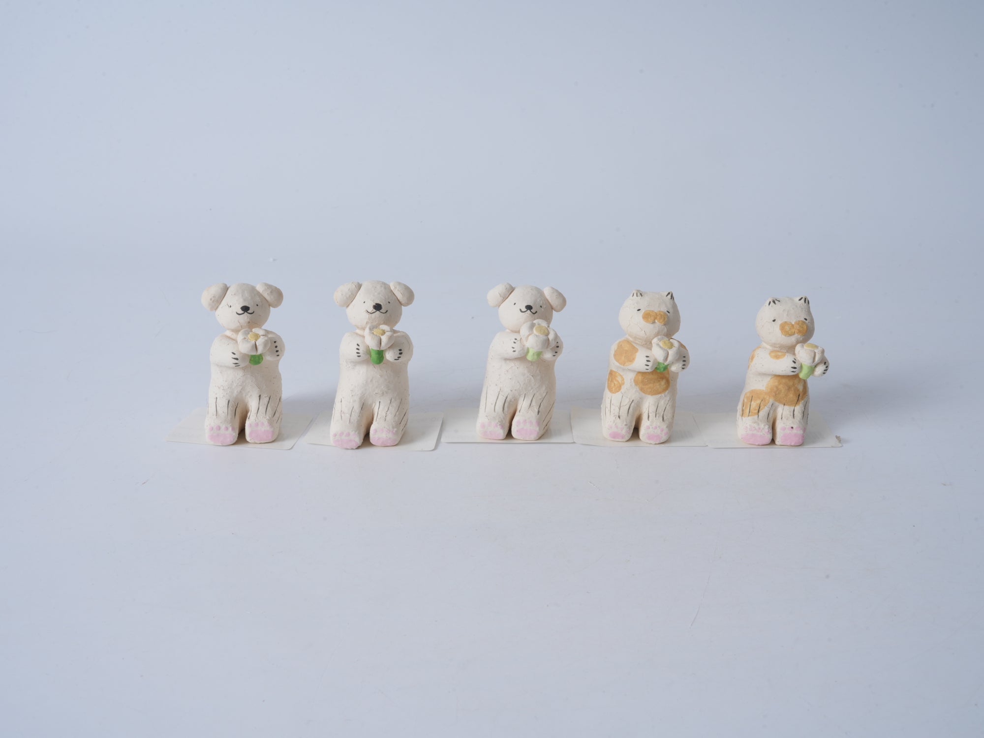 Small Animal Holding Flower Figurine