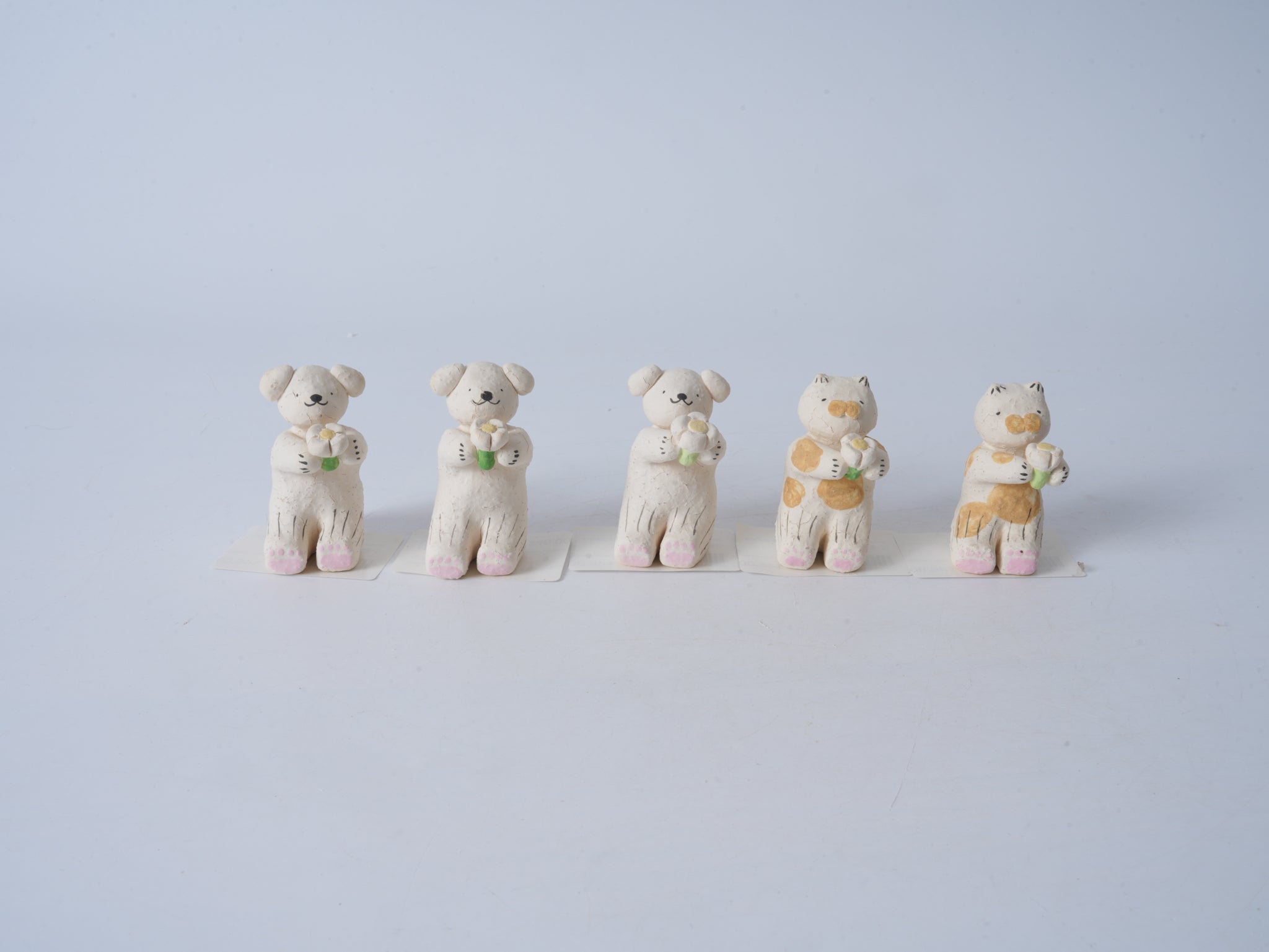 Small Animal Holding Flower Figurine