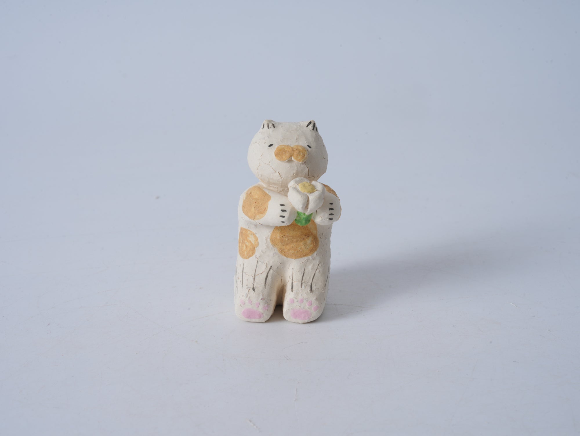 Small Animal Holding Flower Figurine