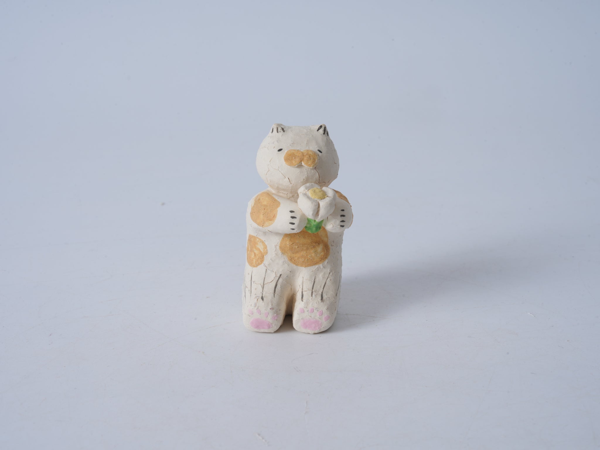 Small Animal Holding Flower Figurine