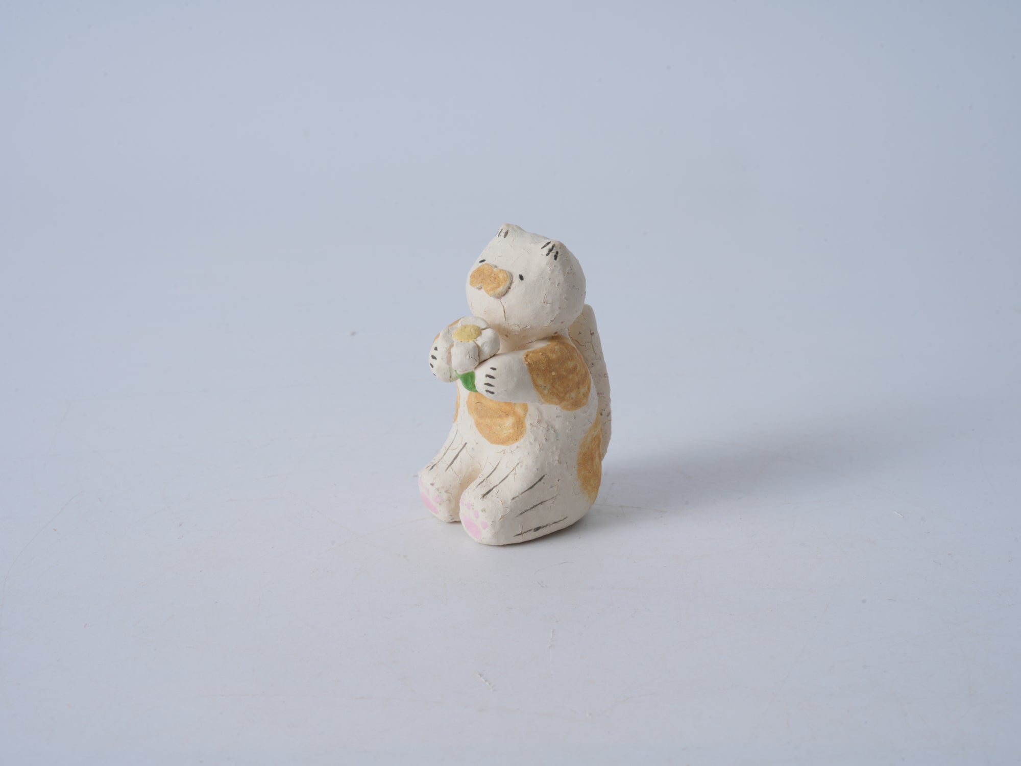 Small Animal Holding Flower Figurine