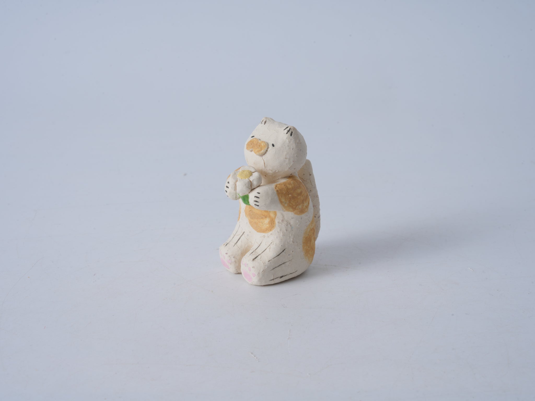 Small Animal Holding Flower Figurine