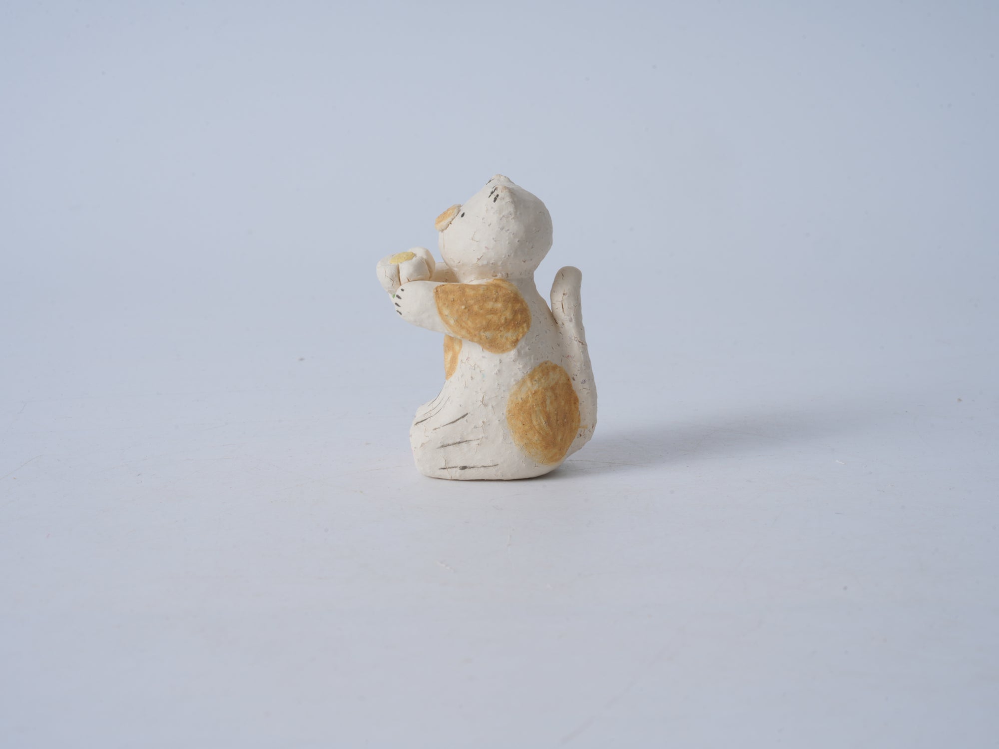 Small Animal Holding Flower Figurine
