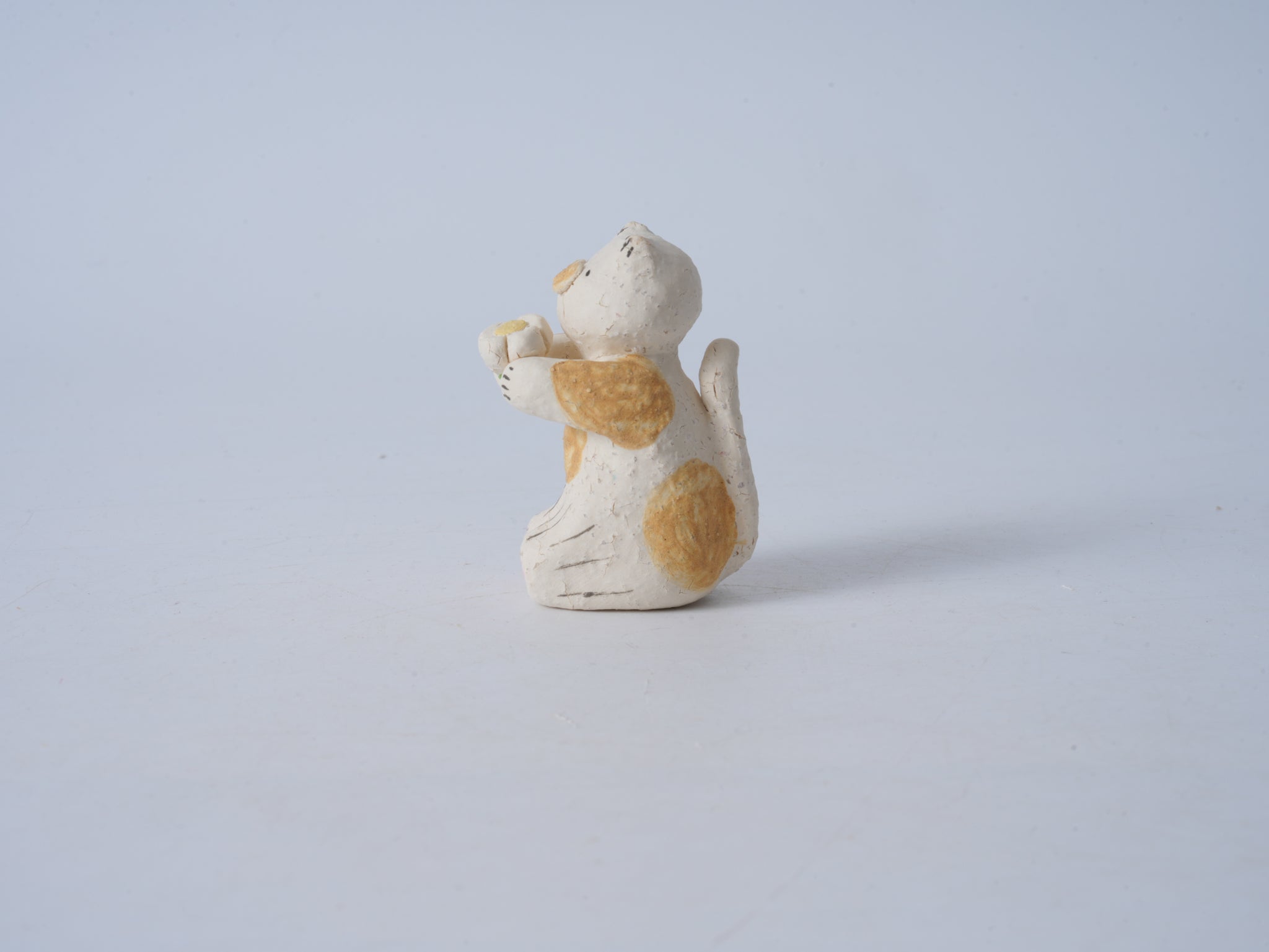 Small Animal Holding Flower Figurine