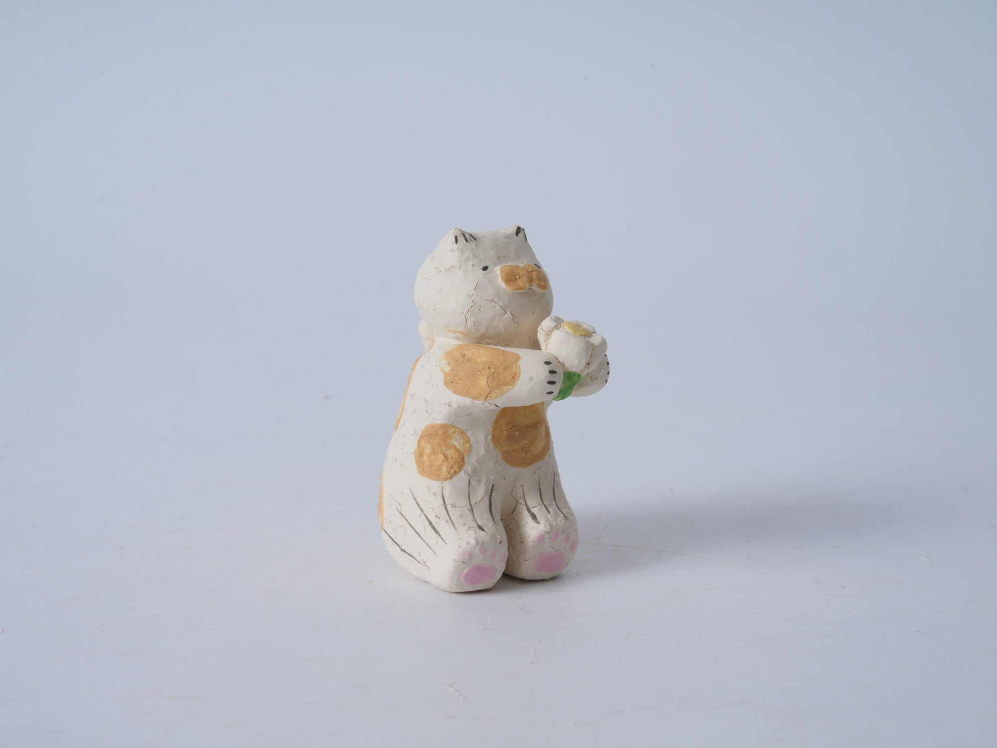 Small Animal Holding Flower Figurine