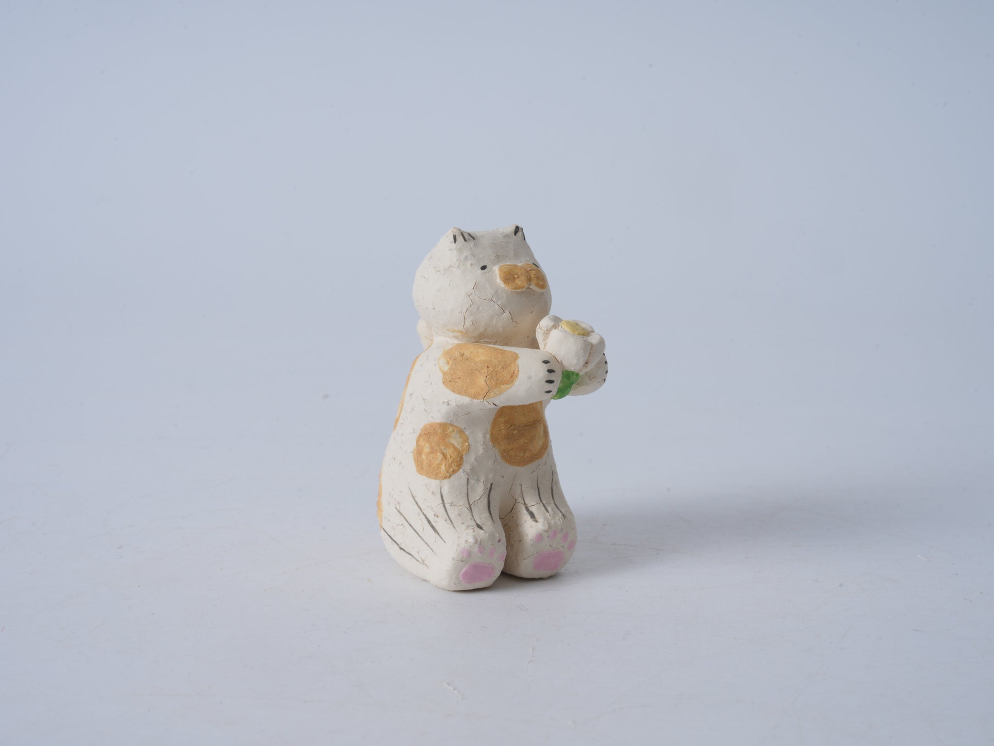 Small Animal Holding Flower Figurine