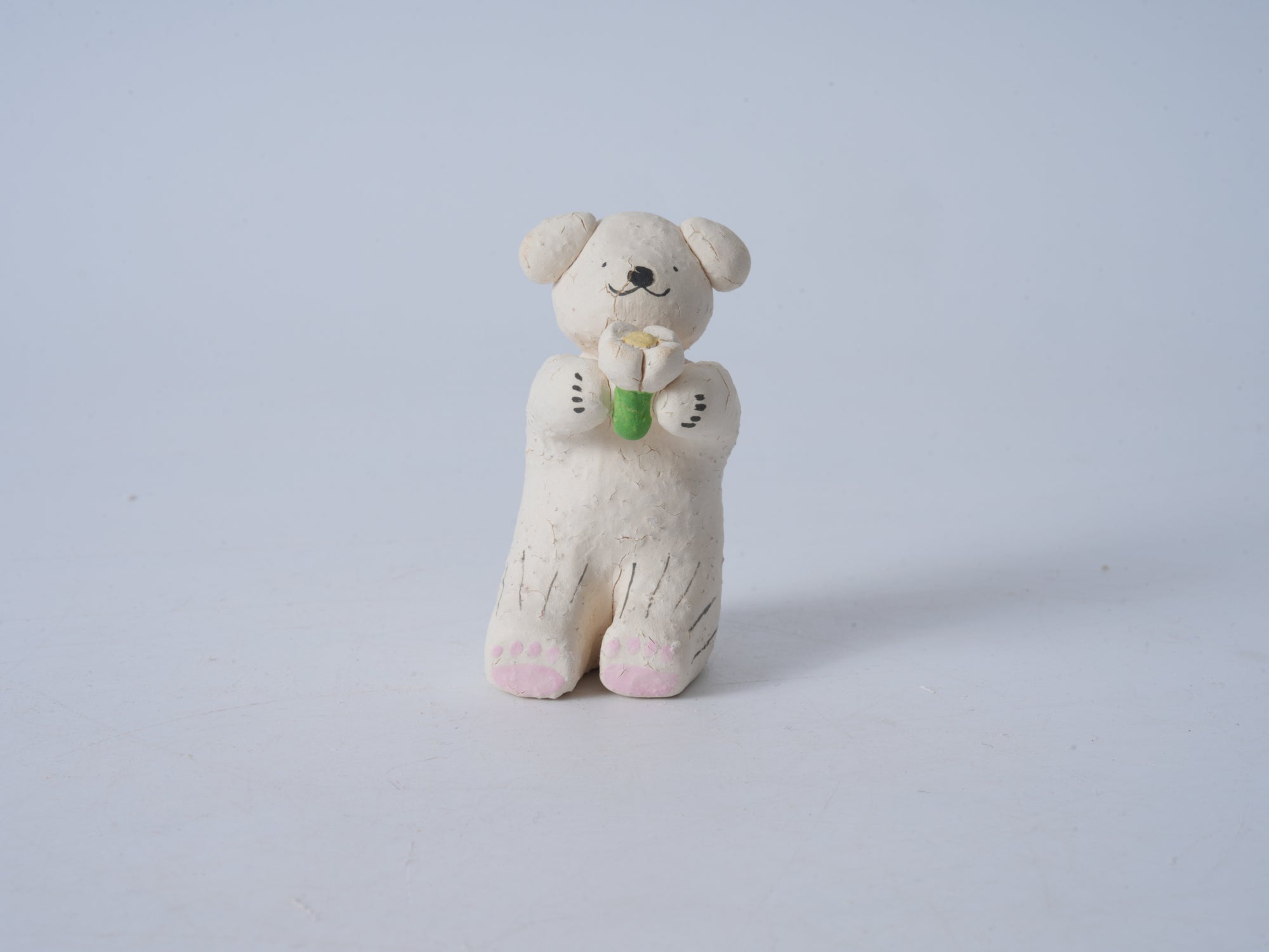 Small Animal Holding Flower Figurine